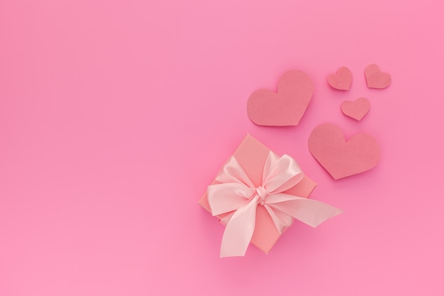 Valentine's day composition: one pink gift boxes with ribbon