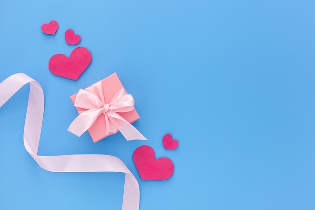 Valentine's day composition: one pink gift boxes with ribbon