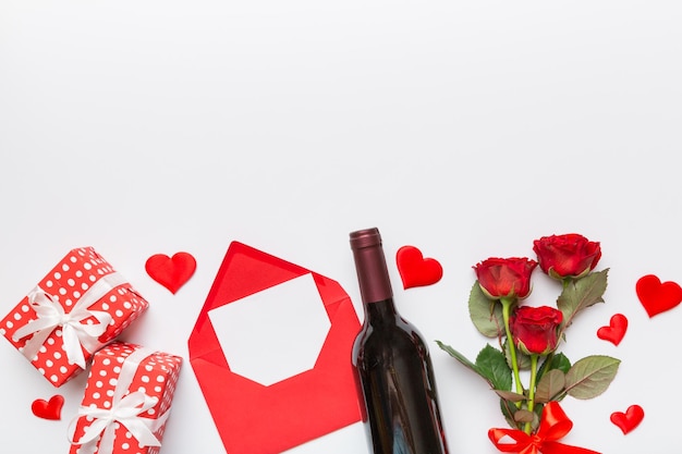 Valentine's day composition with red wine rose flower and gift box on table Top view flat lay copy space