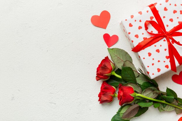 Valentine's day composition with rose flower red heart and gift boxes on table mother day and birthday greeting copy space top view