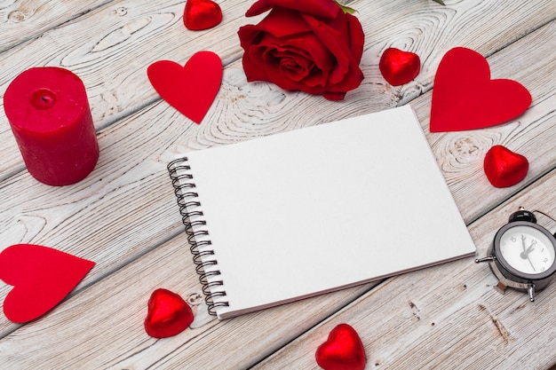 Valentine's day concept. Empty blank notebook, gift box, flowers