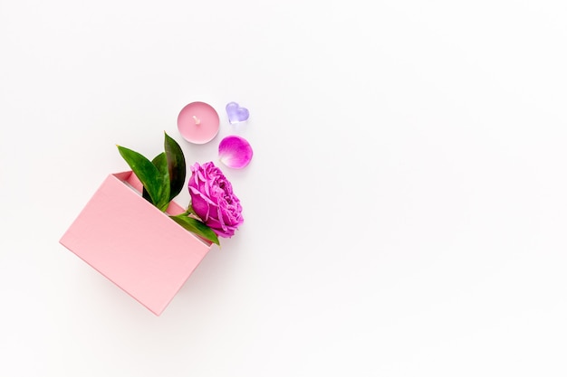 Valentine's day concept. Pink box with marmalade and macaroons and a beautiful rose on a pink table