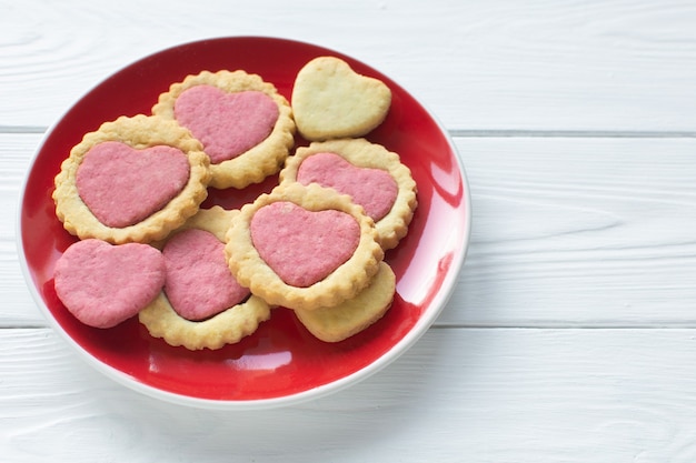 Valentine's day cookies on a plate Step by step 5. Cooking instructions. Love concept. Homemade heart shaped cookies. Delicious natural organic cookies, baked goods with love for valentines day