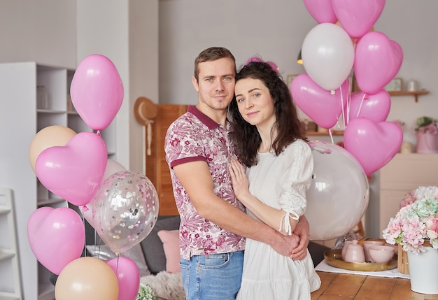 Valentine's Day Couple in love are hugging Flowers and balloons Birthday party