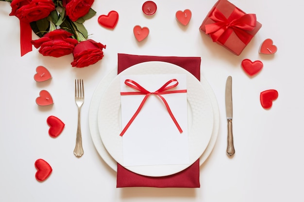 Valentine's day dinner. Romantic table setting with red roses. View from above.