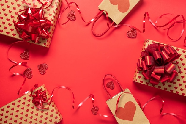 Valentine's day gift box and hearts on red background