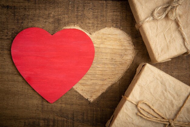 Valentine's Day greetings concept Heart shape carved on the wood with Gift boxes Valentines greeting card Free space for your text