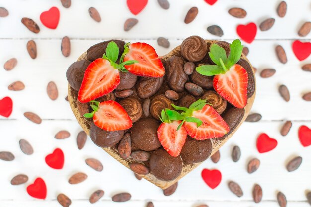 Valentine's day heart shaped box with chocolates and fresh strawberries