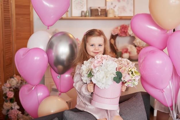 Valentine's Day International Day of Happiness Studio apartment in loft style Holiday decor Child girl with pink balloons and flowers