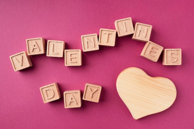 Valentine's Day is made up of wooden cubes flat lay top view Happy Valentine's day concept Bright background for a greeting card The theme of love and romance