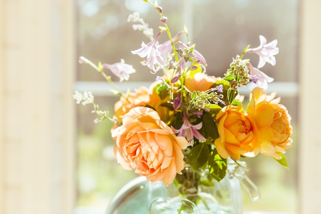 Valentine's Day orange English rose flowers in a glass jar