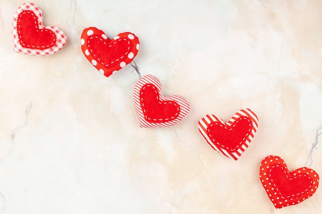 Valentine's decoration with Handmade Red Sewed Pillow Hearts in Row