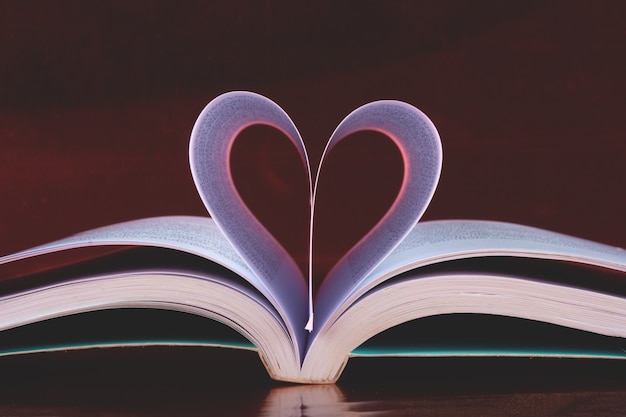 Valentineâs day background with open book and heart-shaped pages.