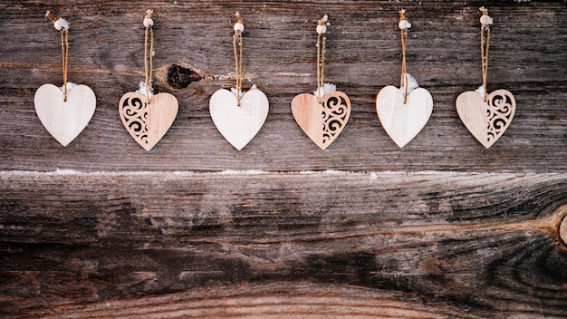 Valentines day background brown old natural boards in grunge style with wooden decorative hearts cop...