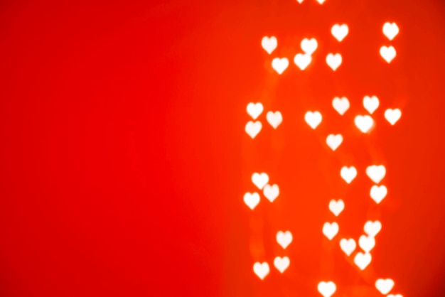 Valentines day background white hearts bokeh on red background