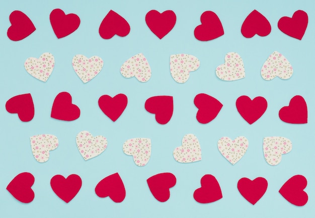 Valentines Day background with lots of felt red and white with flowers hearts