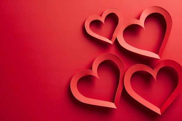 Valentines day background with red paper hearts on red background