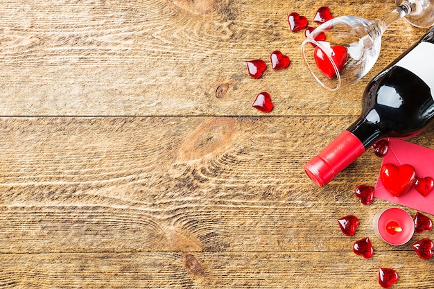 Valentines day background with red wine, wine glass and a card