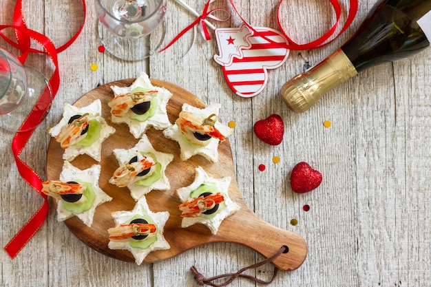 Valentines day or birthday romantic antipasto Canapes with cheese cucumber and shrimps Top view