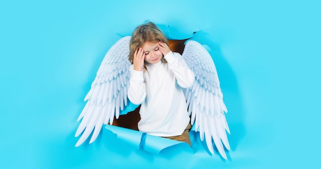 Valentines day blonde cute child in angel wings cupid boy angelic kid in paper hole banner