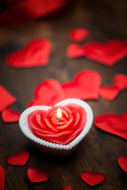 Valentines day candle and shape hearts composition