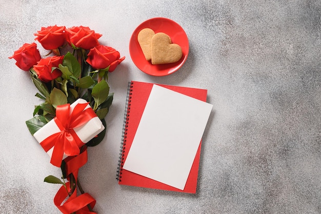 Valentines day card with romantic gift red roses and heart shaped cookies