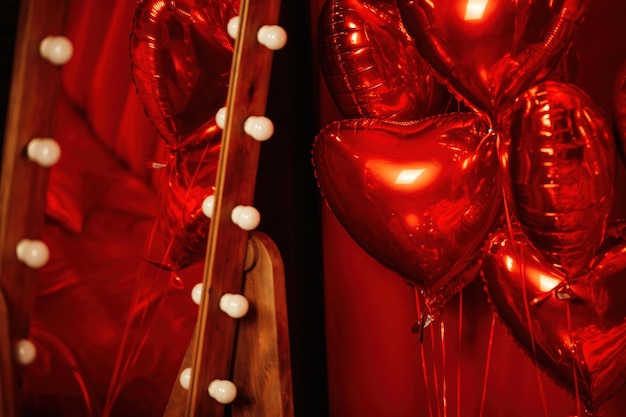 Valentines day celebration at rich room interior with red inflatable glossy balloons by heart shaped