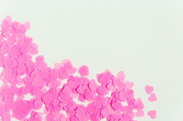 Valentines day composition White background with pink heart shape confetti