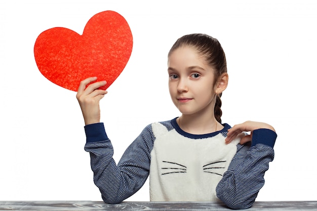 Valentines Day concept - little girl with red heart . Isolated on studio white background female model