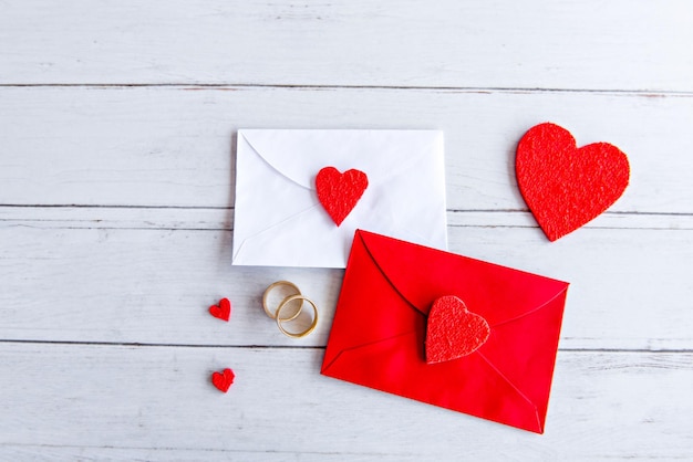 Valentines day concept love letter and wedding rings on wooden table