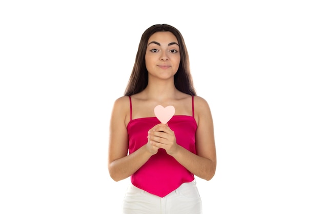 Valentines Day concept Portrait of cute teen girl with pink heart isolated on white background Smiling young girl holds symbol of love family hope