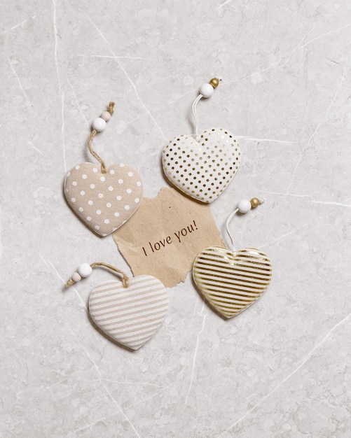 Valentines day concept Soft toy hearts from linen cloth with gold color striped or dots on marble