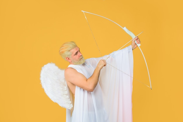 Valentines day concept valentines cupid arrow of love cupid throws arrow with bow bearded angel with