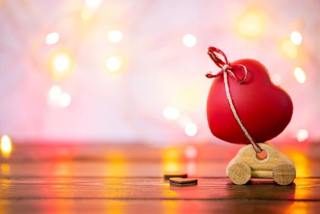 Valentines Day concept with car and heart shape on bokeh background