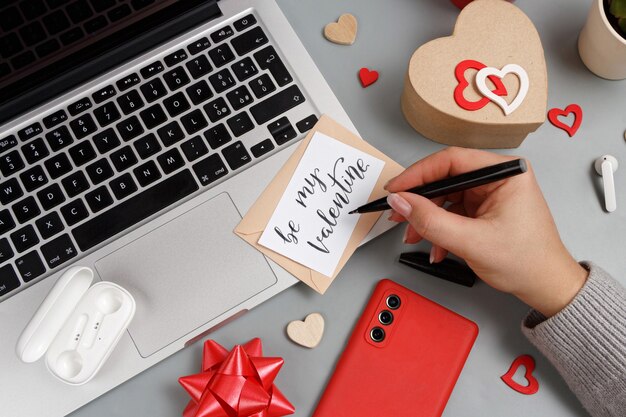 Valentines Day concept with modern gadgets and BE MY VALENTINE card top view on grey table