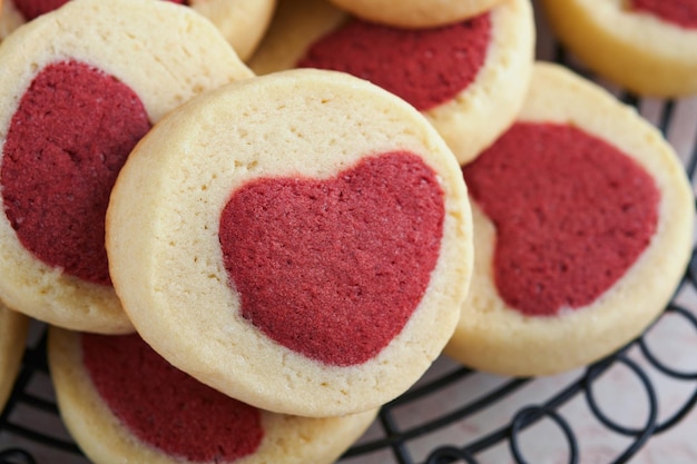 Valentines day cookies Shortbread cookies inside a sweet red heart on pink plate on pink background Mothers day Womans day Sweet holidays baking Top view