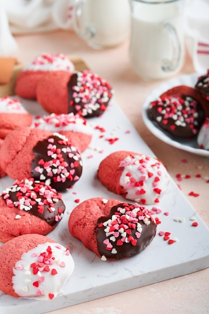 Valentines day cookies Shortbread cookies with glaze white and dark chocolate and heart sprinkles on plate on white background Mothers day Womans day Sweet holidays baking Top view