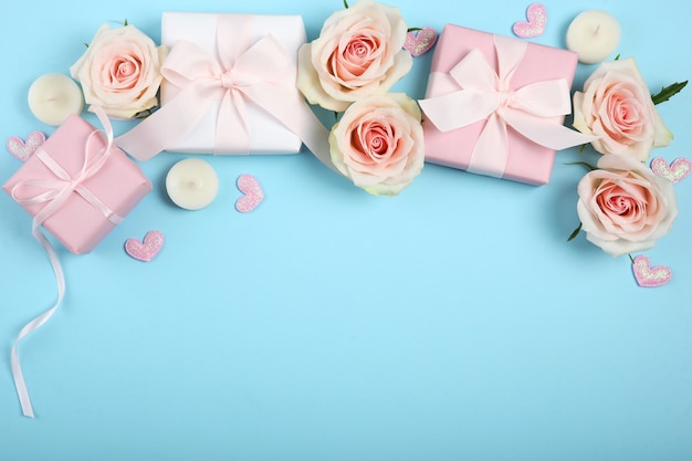 Valentines day decorations, bouquet and gifts on blue background