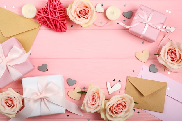 Valentines day decorations, bouquet and gifts on pink background