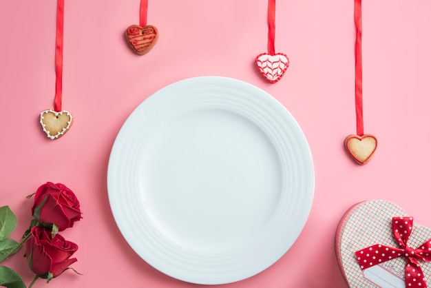 Valentines day dinner on pink background. View from above.