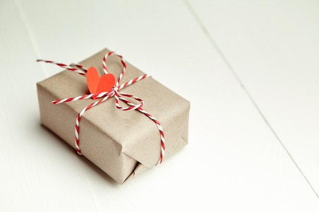 Valentines day gift box decorated with red heart on white background