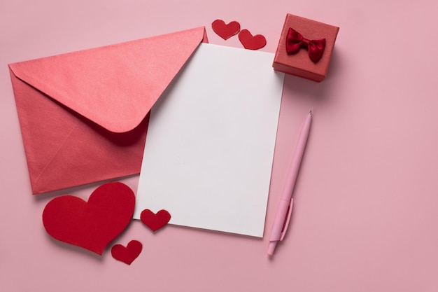 Photo valentines day gift in the box letter and envelope with copy space on pink background ring