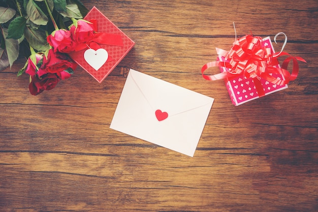 Valentines day gift box red and pink on wood Valentines day card red rose flower and gift box