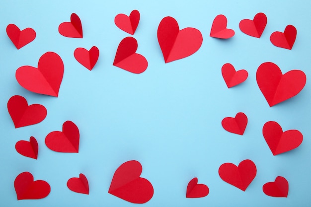 Valentines day greeting card. Handmaded red hearts on blue background.