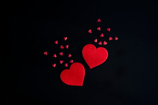 Valentines day and heart shapes on black background