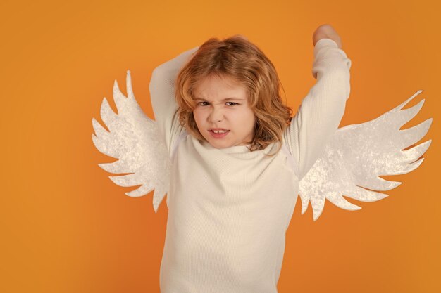 Photo valentines day kid with angel wings studio portrait of angel child on studio color isolated