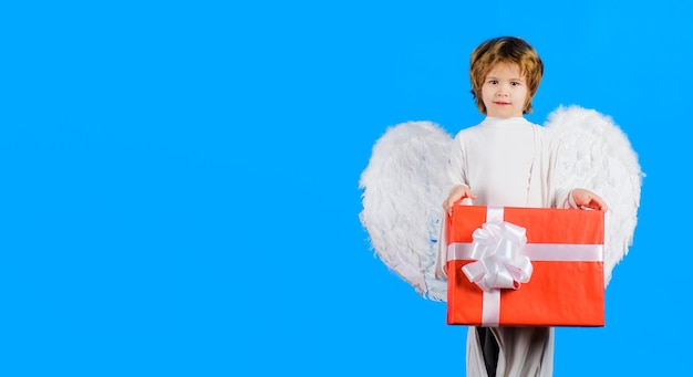 Valentines day little angel in wings with valentine present cupid boy with gift box february