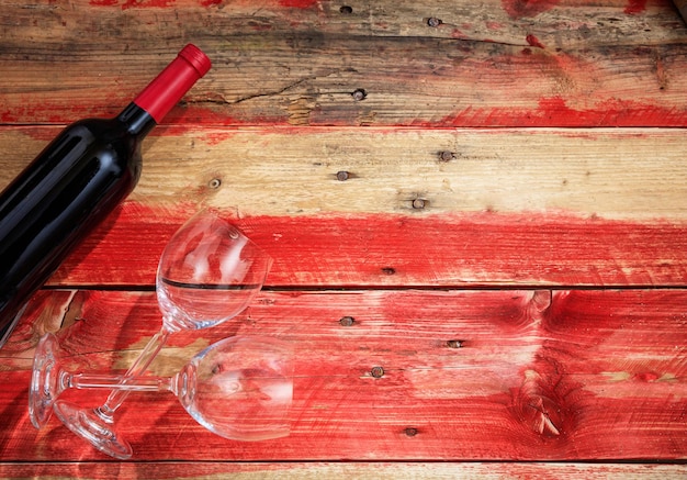 Valentines day Red wine bottle and glasses on wooden background