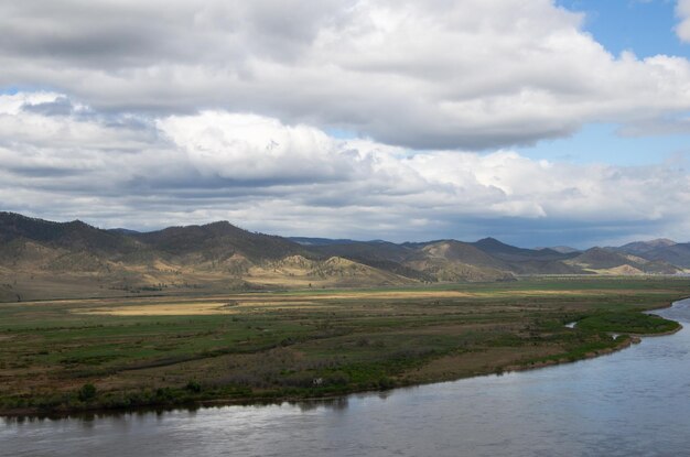 The valley of the river under an overcast cloudy sky View of the river from a height