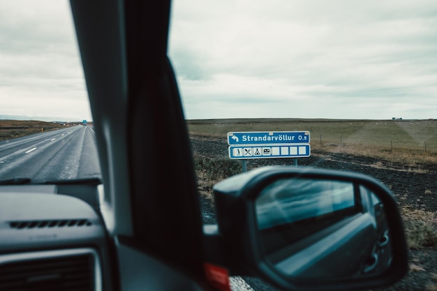 Van dashboard on the iceland road against a cloudy rainy day Lifestyle travel tourism nature active life amazing cinematic scandinavian landscape Travel on epic road trip through mountains